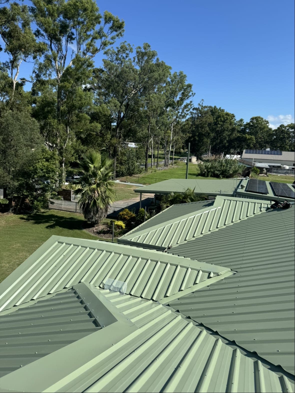 New pale green Colorbond roof with several hips and valleys on an acreage home